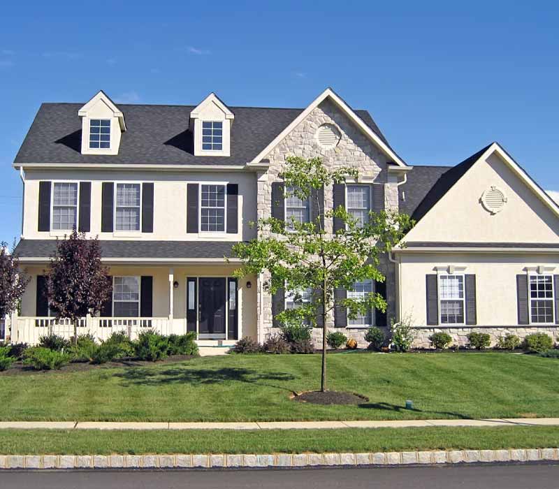 Two story white home with stone siding